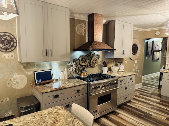 kitchen featuring ornamental molding, luxury stove, wall chimney exhaust hood, and wood finished floors