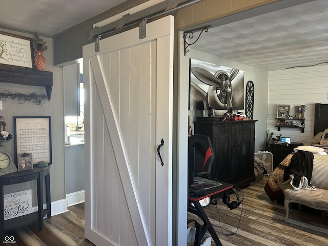 interior space with a barn door and wood finished floors