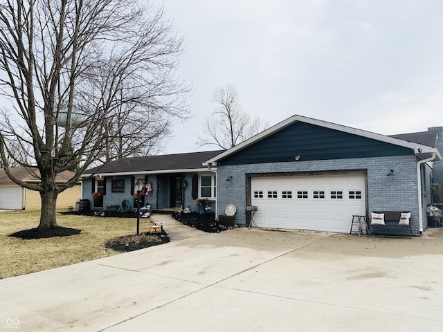 single story home with driveway, brick siding, an attached garage, and a front yard