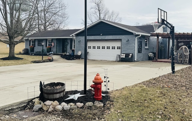 exterior space featuring concrete driveway, brick siding, an attached garage, and a pergola