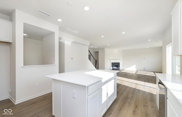 kitchen featuring white cabinetry, visible vents, and wood finished floors