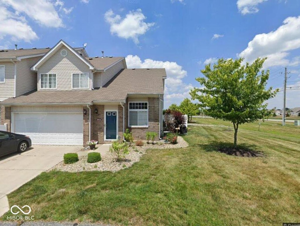 5944 Streamwood Ln, Indianapolis, IN 46237 - view of front of house with driveway, a front lawn, a garage, and brick siding