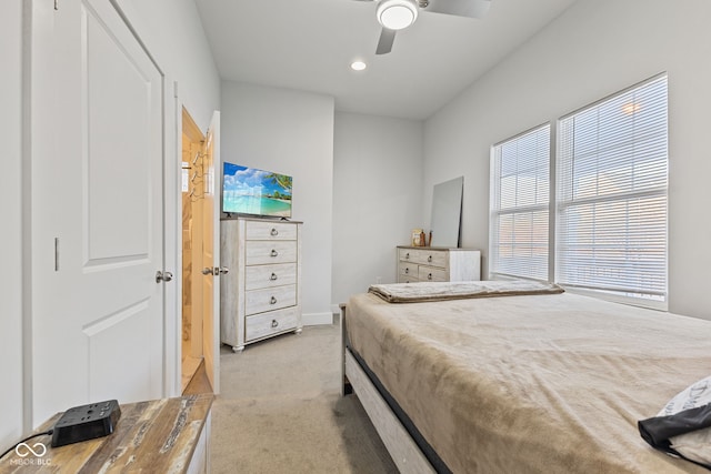 bedroom with a ceiling fan and light colored carpet