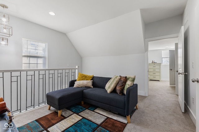 living area with a wealth of natural light, carpet flooring, and lofted ceiling