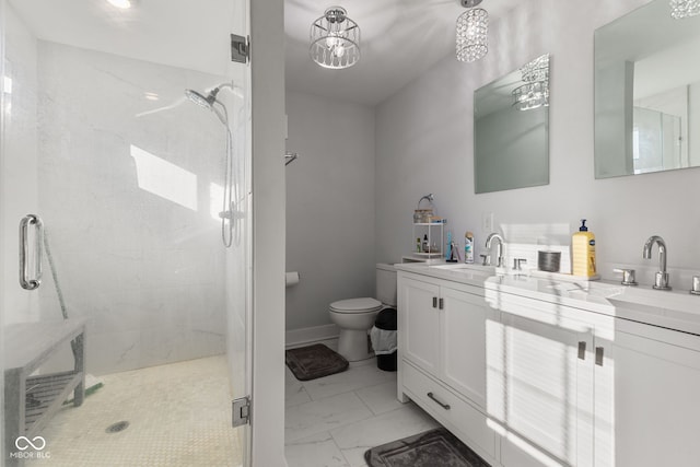 bathroom featuring marble finish floor, double vanity, a stall shower, and a sink