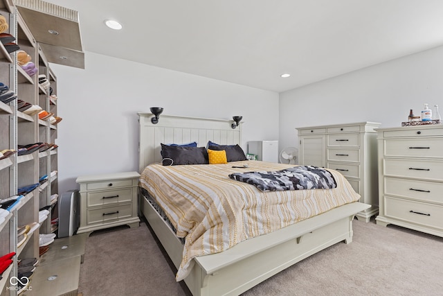 bedroom featuring light carpet and recessed lighting