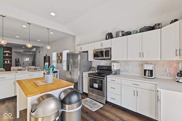 kitchen featuring pendant lighting, appliances with stainless steel finishes, and white cabinets