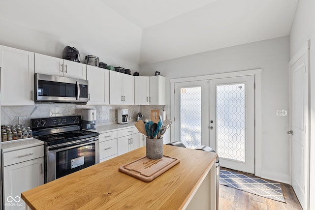 kitchen featuring stainless steel appliances, french doors, light countertops, and white cabinetry