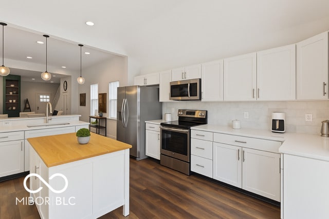 234 N State Ave, Indianapolis, IN 46201 - kitchen featuring appliances with stainless steel finishes, recessed lighting, white cabinets, wooden counters, and hanging light fixtures