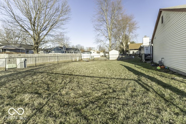 view of yard with a fenced backyard and a residential view