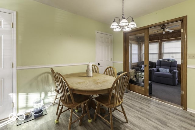 dining space featuring a chandelier and light wood finished floors