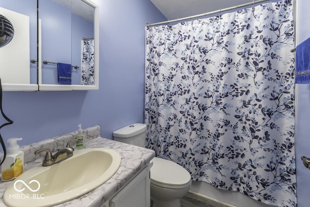 full bathroom with curtained shower, vanity, and toilet