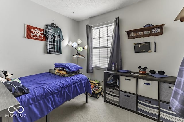 bedroom with carpet floors and a textured ceiling