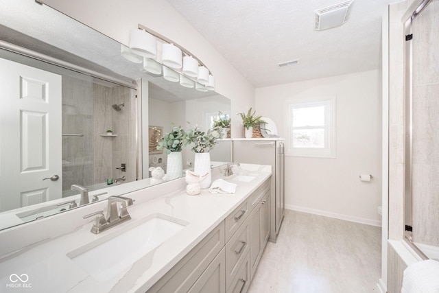 full bath with toilet, visible vents, a sink, and a shower with door