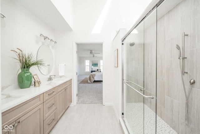 ensuite bathroom with a sink, a shower stall, double vanity, and connected bathroom