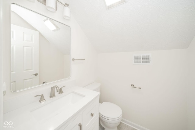 bathroom with visible vents, toilet, lofted ceiling, a textured ceiling, and vanity