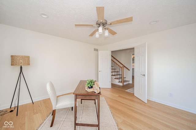 office with light wood-type flooring, visible vents, and baseboards