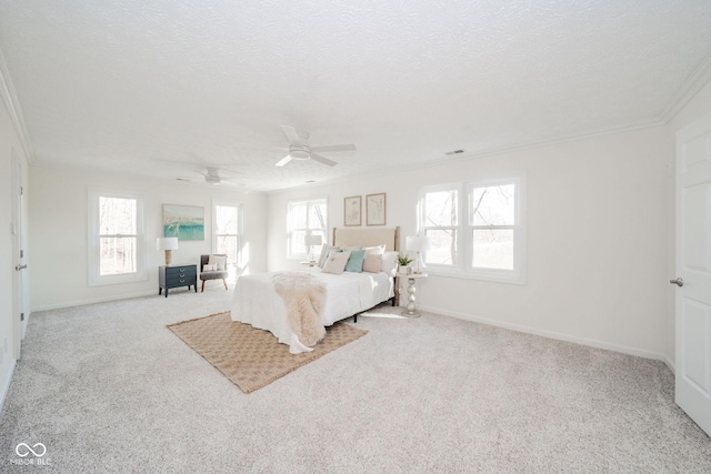 bedroom featuring light carpet, baseboards, ornamental molding, and a textured ceiling