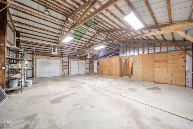 garage with a garage door opener and metal wall