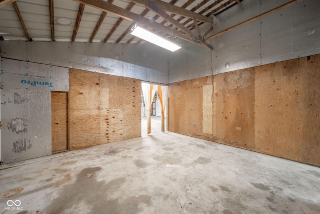 interior space with concrete floors and high vaulted ceiling