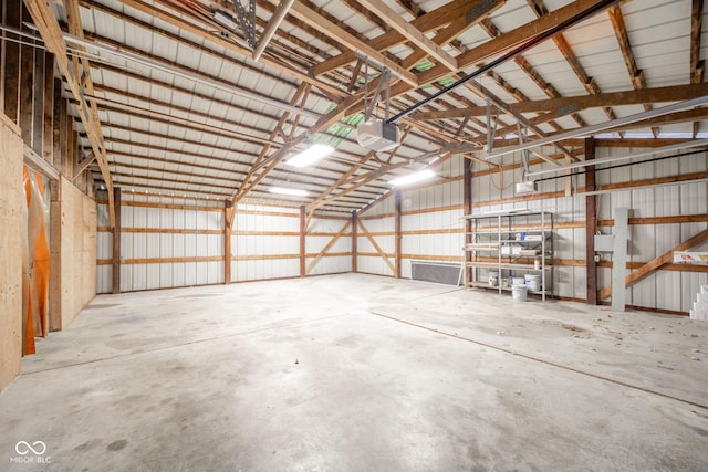 garage with metal wall and a garage door opener