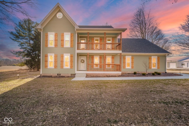 view of front of home featuring covered porch, a yard, a balcony, and crawl space