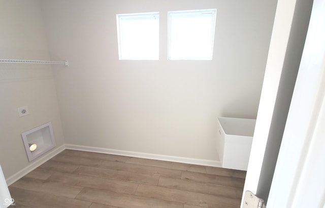 laundry area with light wood-style floors, laundry area, hookup for an electric dryer, and baseboards