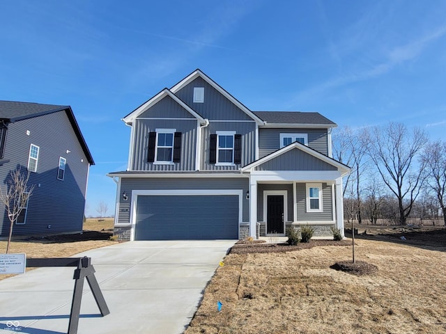 craftsman-style home with board and batten siding, stone siding, a garage, and concrete driveway