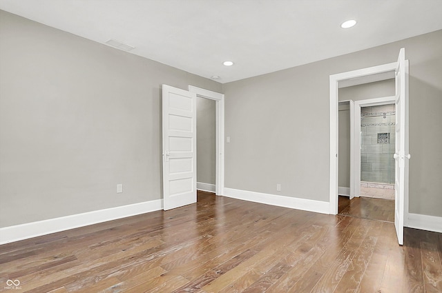 5053 E Michigan St, Indianapolis, IN 46201 - unfurnished bedroom featuring wood finished floors, baseboards, and recessed lighting