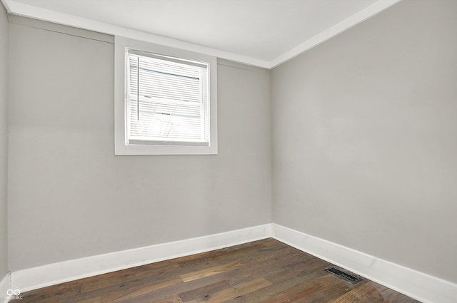 5053 E Michigan St, Indianapolis, IN 46201 - spare room with baseboards, dark wood-style floors, and crown molding