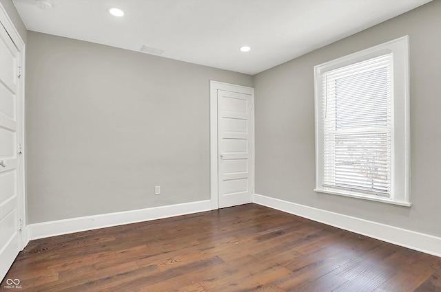 5053 E Michigan St, Indianapolis, IN 46201 - unfurnished bedroom with dark wood-style floors, baseboards, and recessed lighting