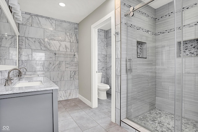 5053 E Michigan St, Indianapolis, IN 46201 - bathroom with a stall shower, toilet, double vanity, tile patterned flooring, and recessed lighting