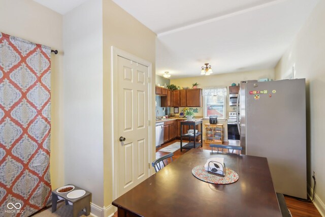 dining space featuring baseboards and wood finished floors