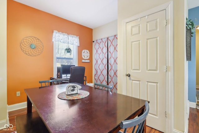 dining area featuring wood finished floors and baseboards