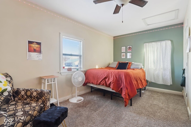 carpeted bedroom featuring a ceiling fan, attic access, and baseboards