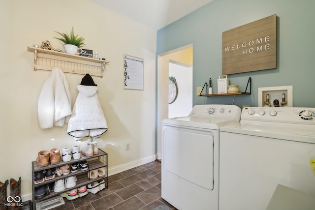 laundry area featuring laundry area, baseboards, and washing machine and clothes dryer