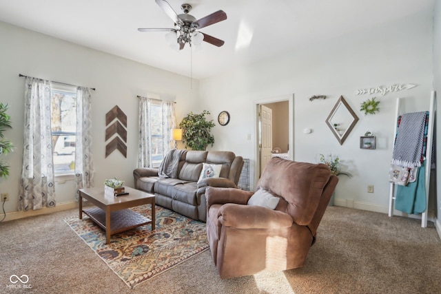 living room with carpet floors, baseboards, and a ceiling fan