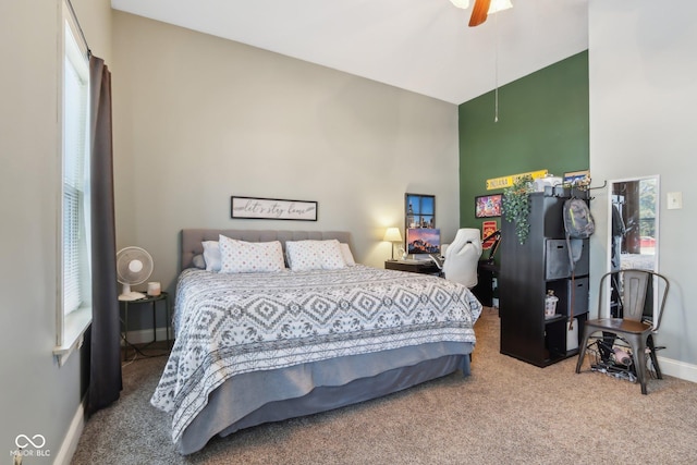 bedroom featuring carpet, ceiling fan, a towering ceiling, and baseboards