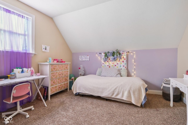 carpeted bedroom with baseboards and vaulted ceiling