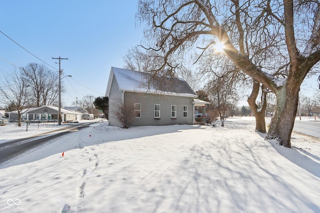 snow covered house with a residential view