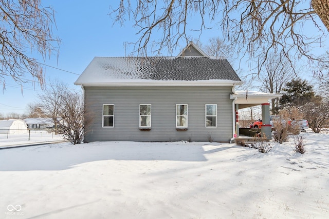 view of snow covered rear of property