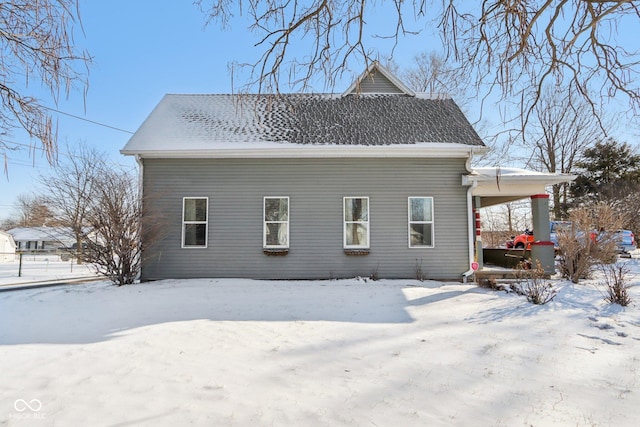 exterior space featuring roof with shingles