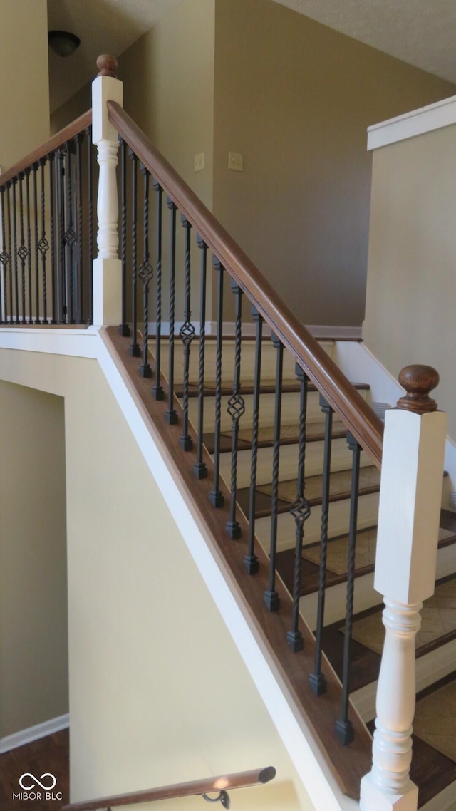 stairway featuring wood finished floors