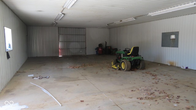 garage featuring electric panel and metal wall