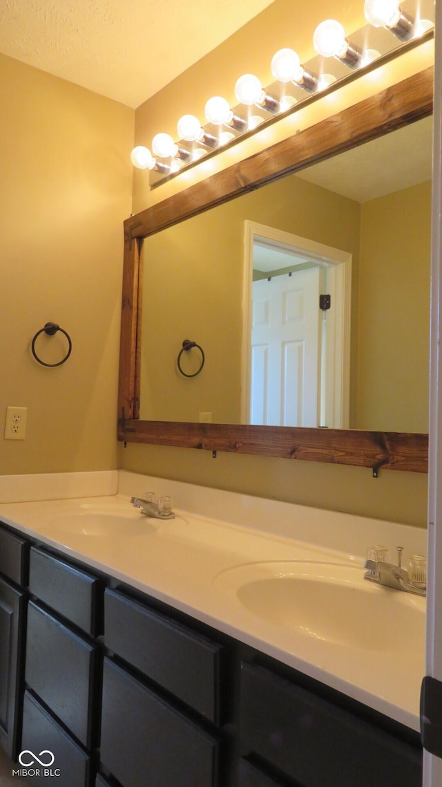 bathroom featuring a sink and double vanity