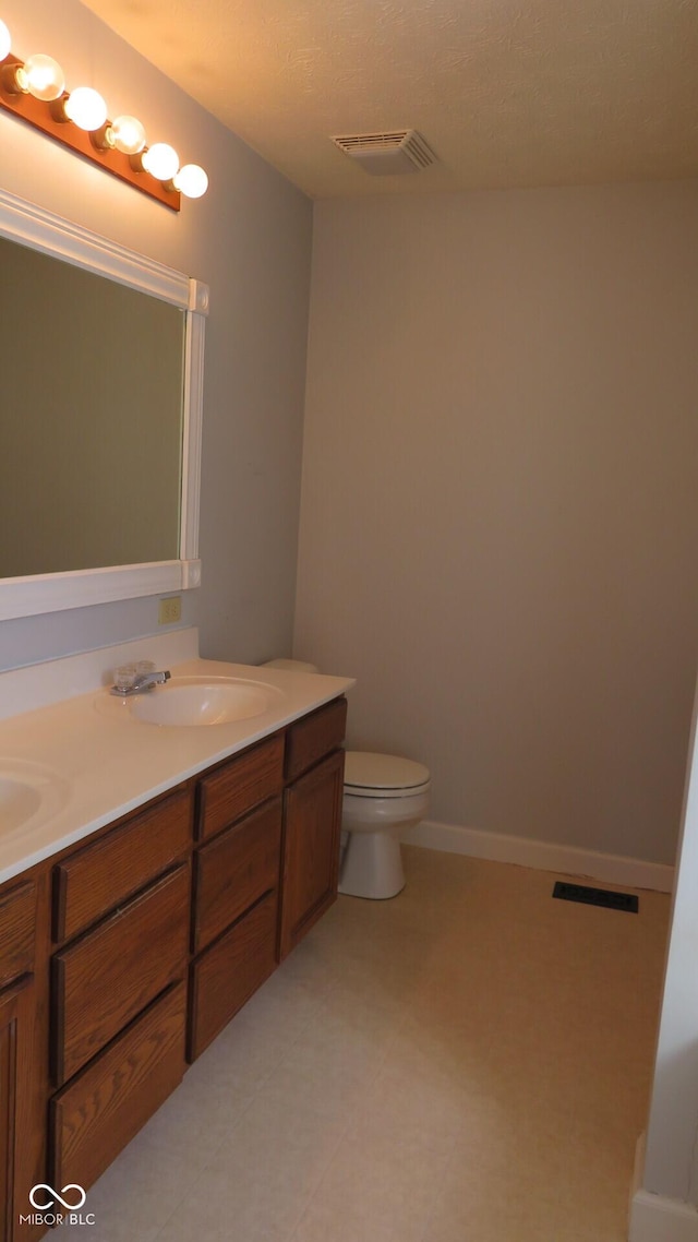 bathroom with double vanity, a sink, and visible vents