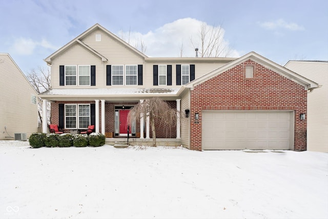 traditional home featuring a porch, brick siding, a garage, and central AC unit