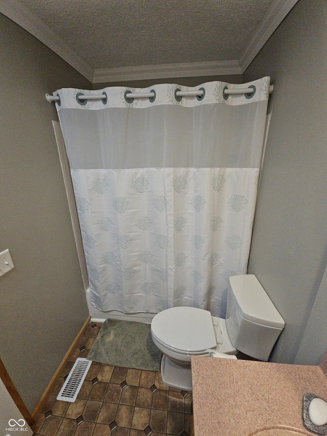 bathroom featuring visible vents, toilet, ornamental molding, tile patterned flooring, and baseboards