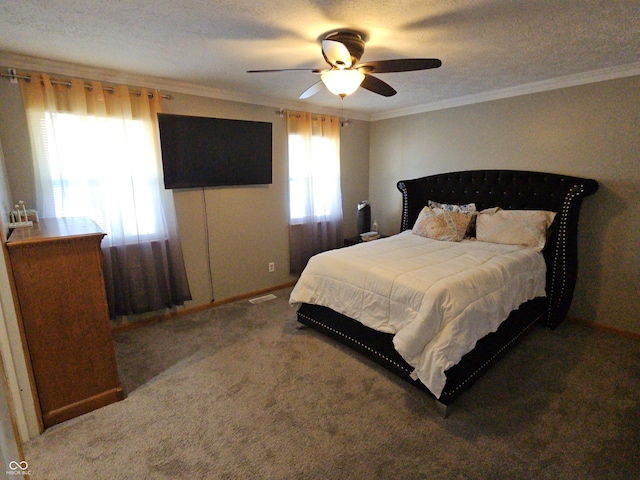 bedroom featuring ceiling fan, ornamental molding, a textured ceiling, and carpet flooring