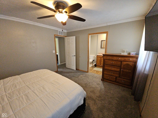 bedroom featuring crown molding, dark colored carpet, visible vents, connected bathroom, and baseboards